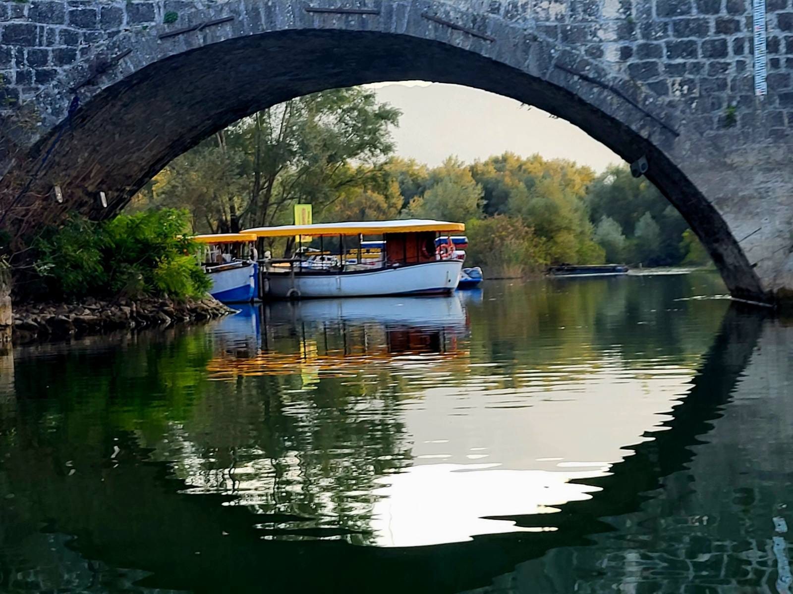 Stone bridge and boats in Virpazar
